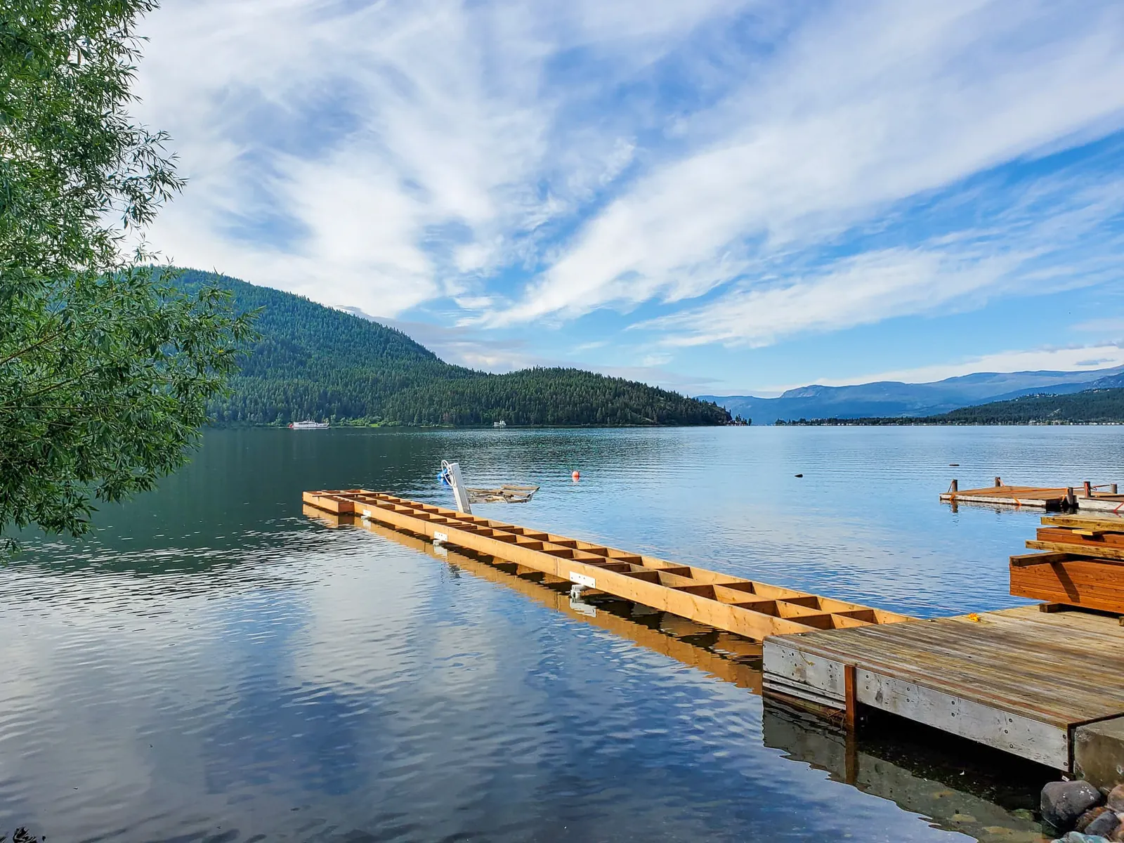 Freshly stained cedar deck wrapping a home in the Shuswap